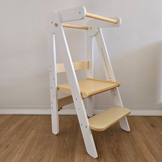 Front angled view of the Four Little Monkeys White Adjustable Foldable Learning Tower, highlighting its sleek design.