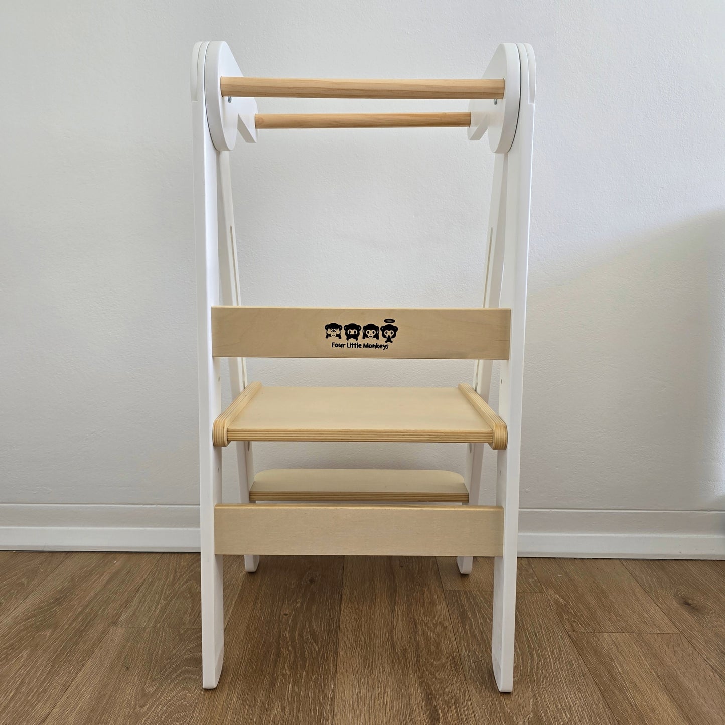Direct rear view of Four Little Monkeys White Adjustable Foldable Learning Tower, featuring the clear display of the brands logo.