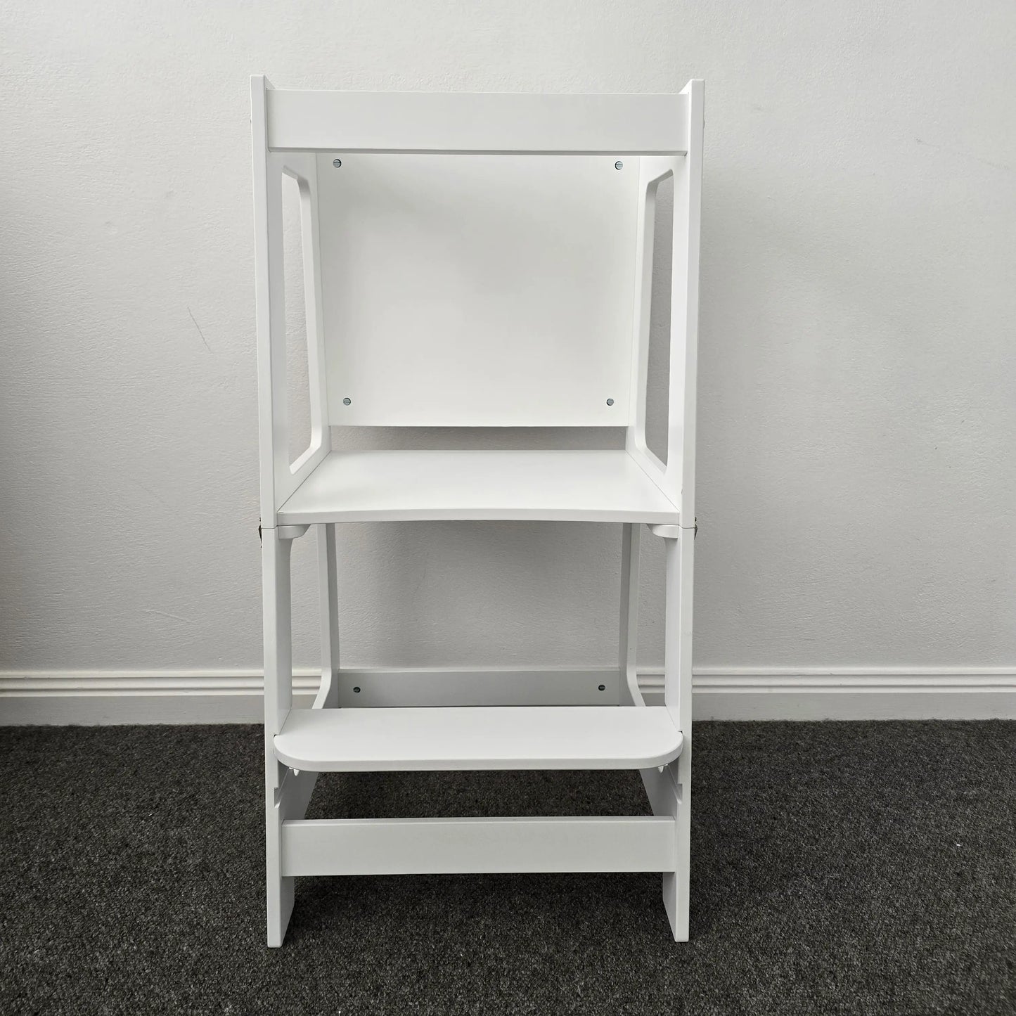Front profile view of the Four Little Monkeys Convertible Learning Tower in its tower configuration, emphasizing its safety locks and sturdy design.