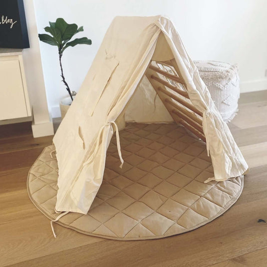 mage depicting a Pikler Triangle paired with a play tent, showcasing an imaginative and versatile playset designed to encourage active play and creativity in children.