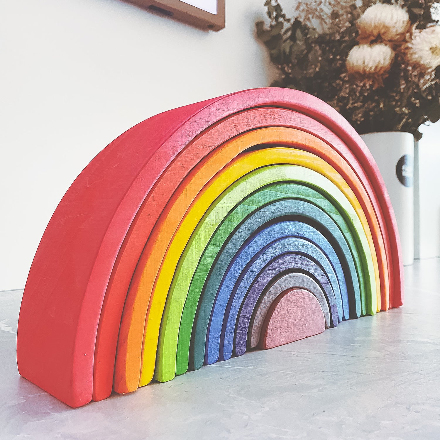 Colourful Rainbow Arch Stacker toy on Four Little Monkeys, made with non-toxic paint on FSC Certified Pine wood for children 6 months and above promoting fine motor skills, strength, and problem-solving.