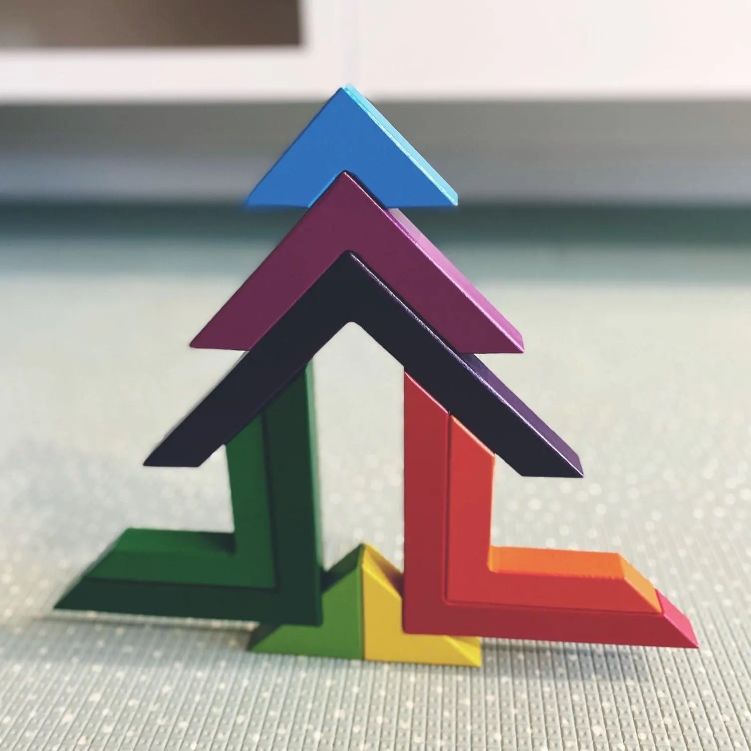 Rainbow Triangle Builder Set from Four Little Monkeys, a colourful and educational toy encouraging creativity and skill development in children
