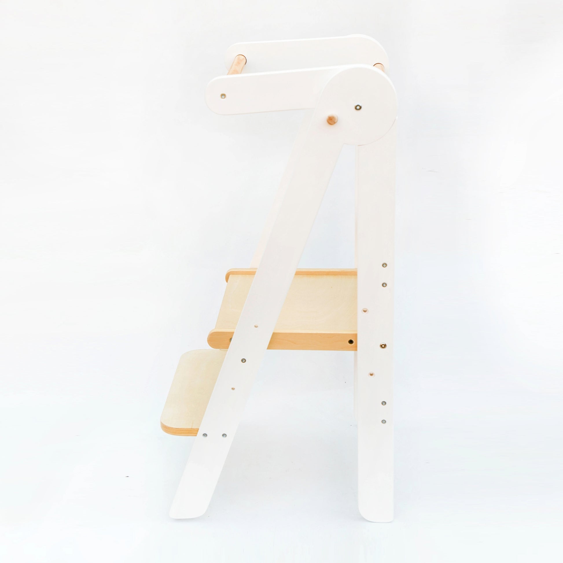 Side view of the White Adjustable Foldable Learning Tower illustrating the sleek design and stability on a white background.