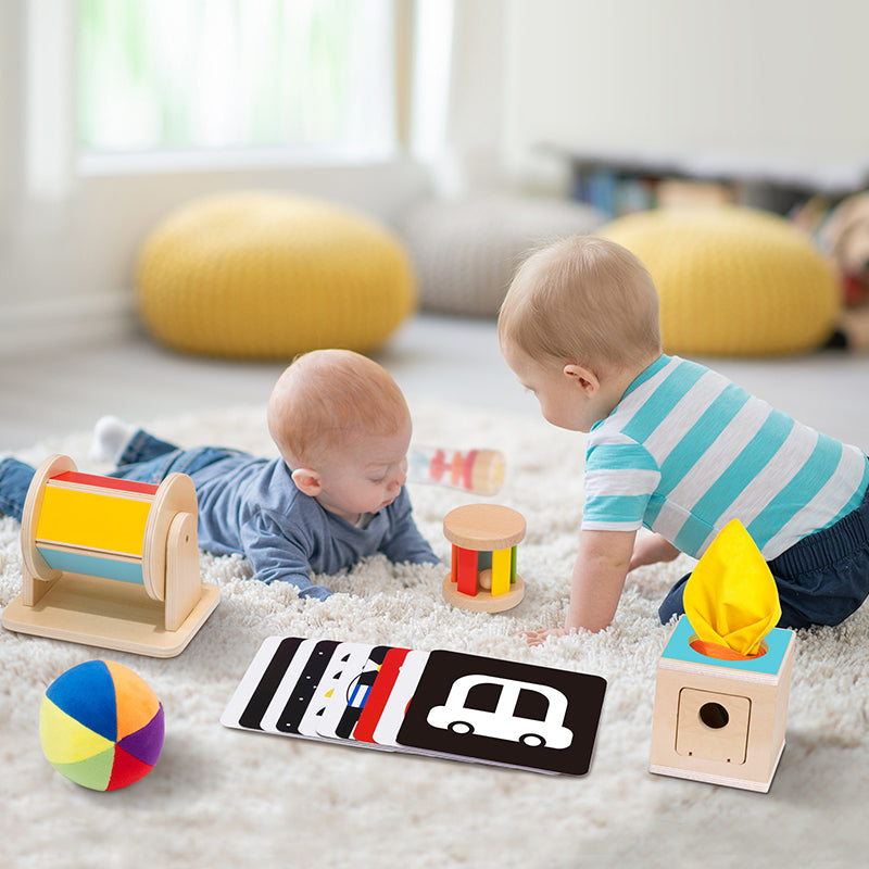 Cute babies interacting with 'Monkeys Learn and Play' toy kit, specifically designed for infants aged 0 to 6 months.