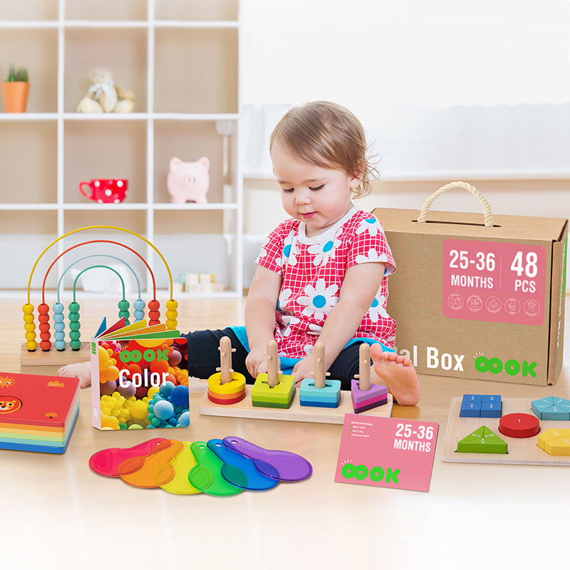 Image of a young child aged between 25-36 months joyfully engaged in play with various vibrant and educational toys from the Monkey's Learn and Play Kit
