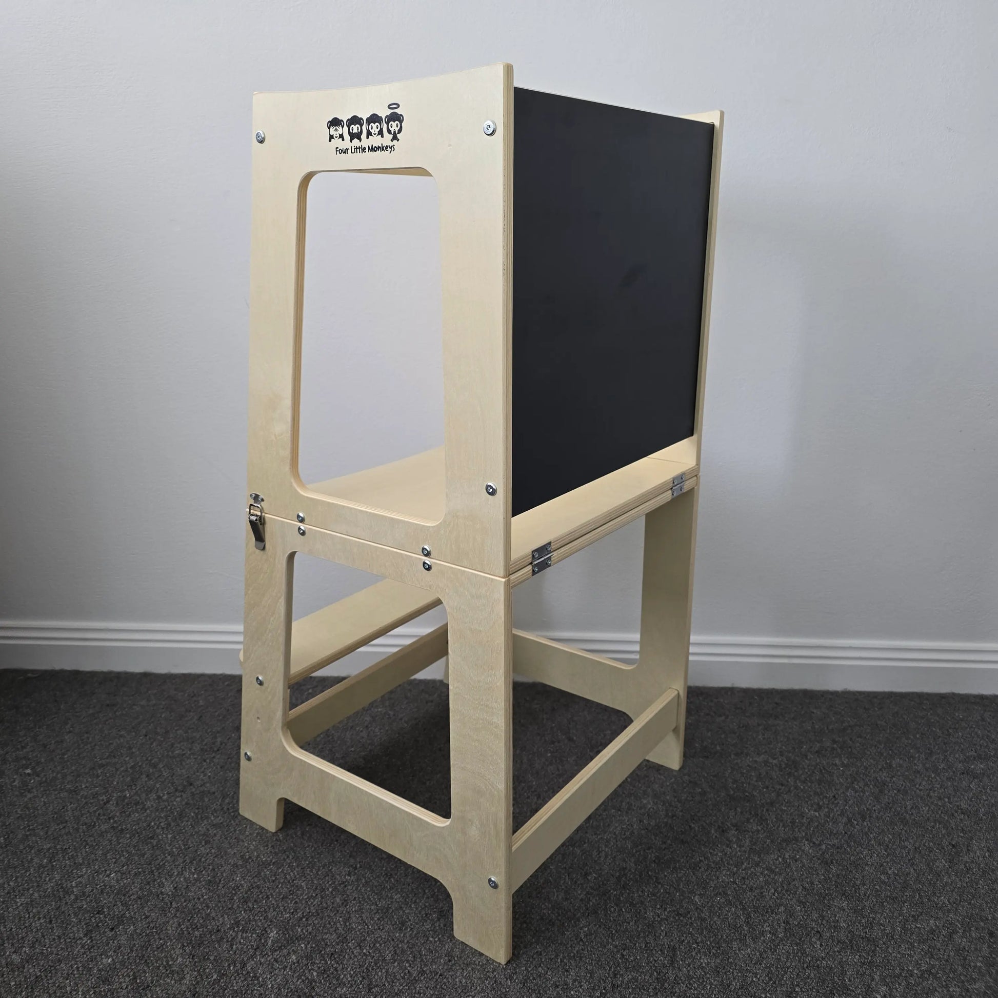 A wooden convertible learning tower in its tower configuration with a natural finish, set against a plain background.