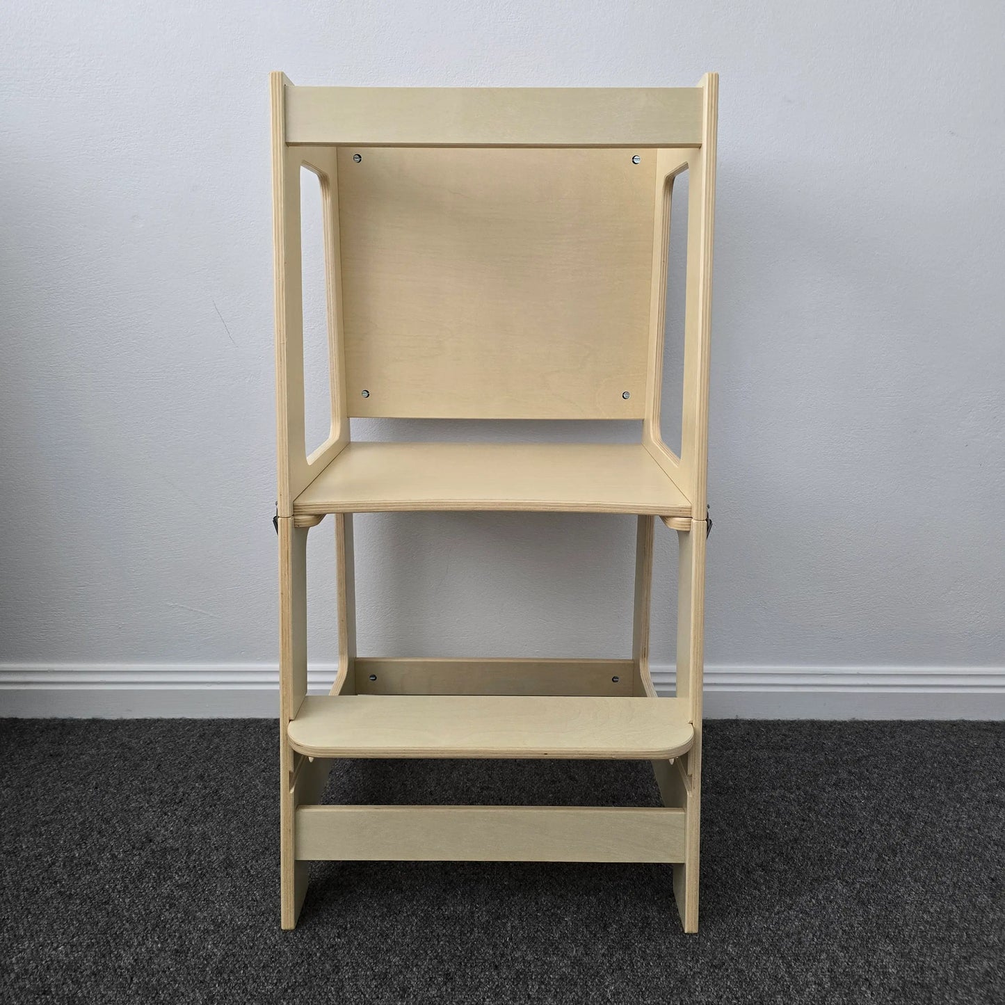 Front profile view of the wooden convertible learning tower, displaying its structure and natural wood finish.