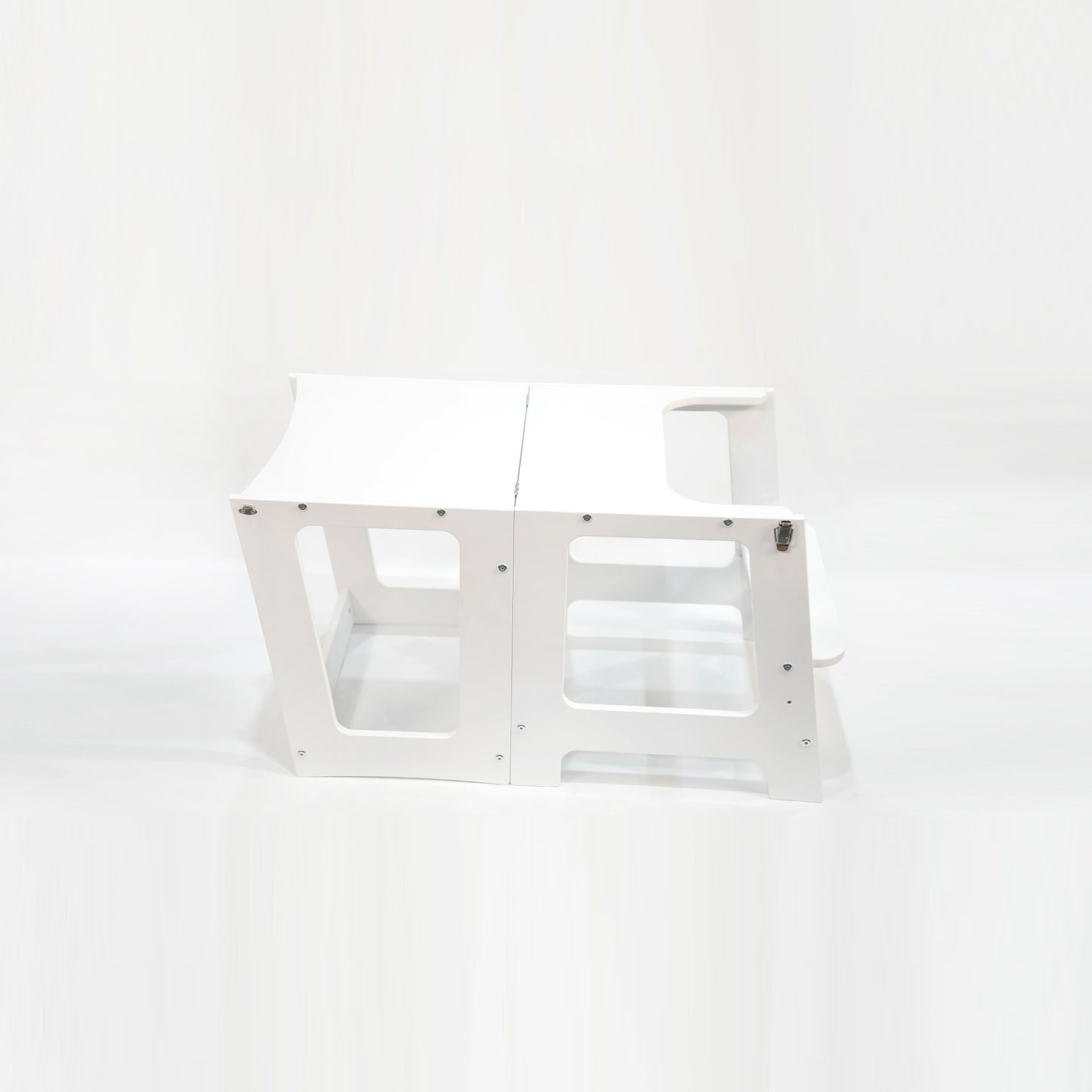 Side angle view of the White Convertible Learning Tower folded down into a table