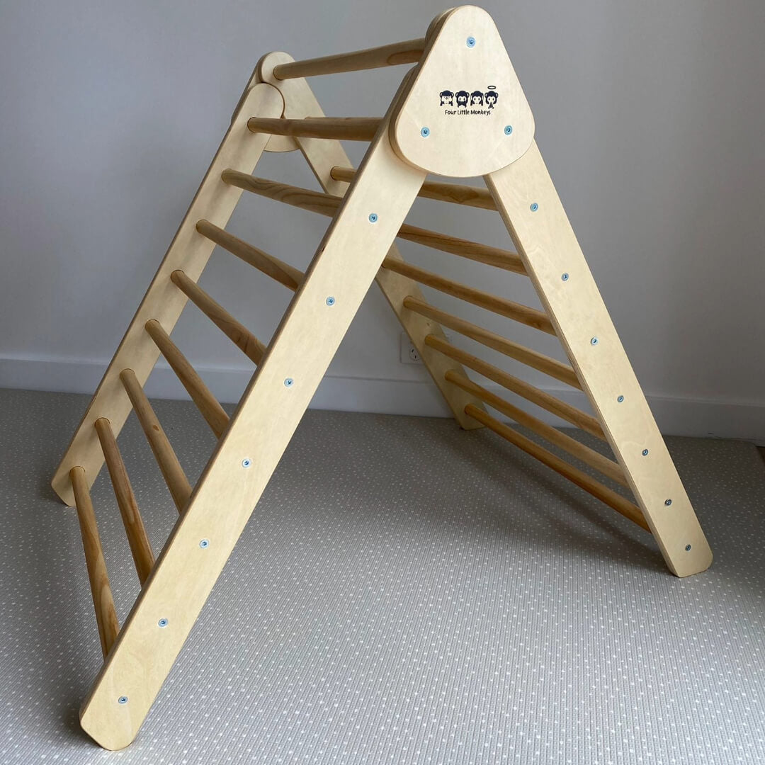 Large Pikler Triangle designed for occupational therapy and child motor skill development, made from birch plywood and able to be folded for easy storage.