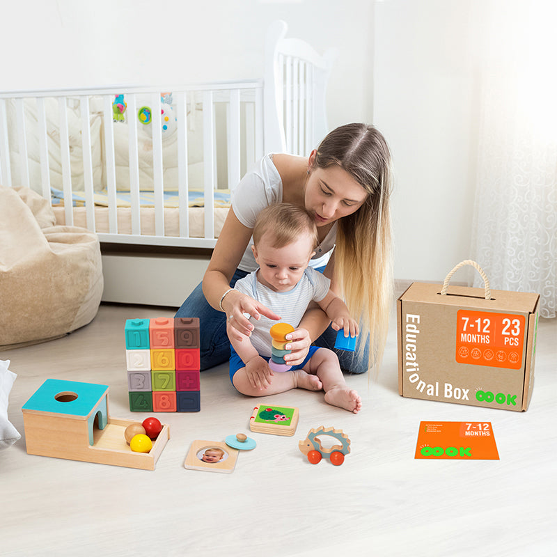 Image of a smiling mother engaging her baby with toys from the Monkey Play and Learn Kit for infants aged 7-12 months. They are having a wonderful bonding time while exploring the toys together.