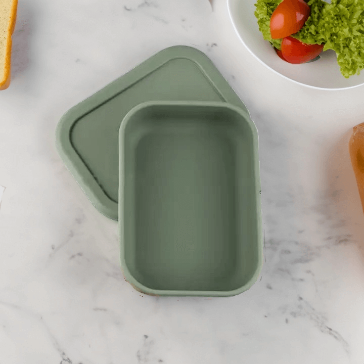 Sage green Silicone Bento Lunch Box with a single compartment, showcasing its soft, kid-friendly design and durable, leak-proof construction for easy and fun lunches on-the-go.