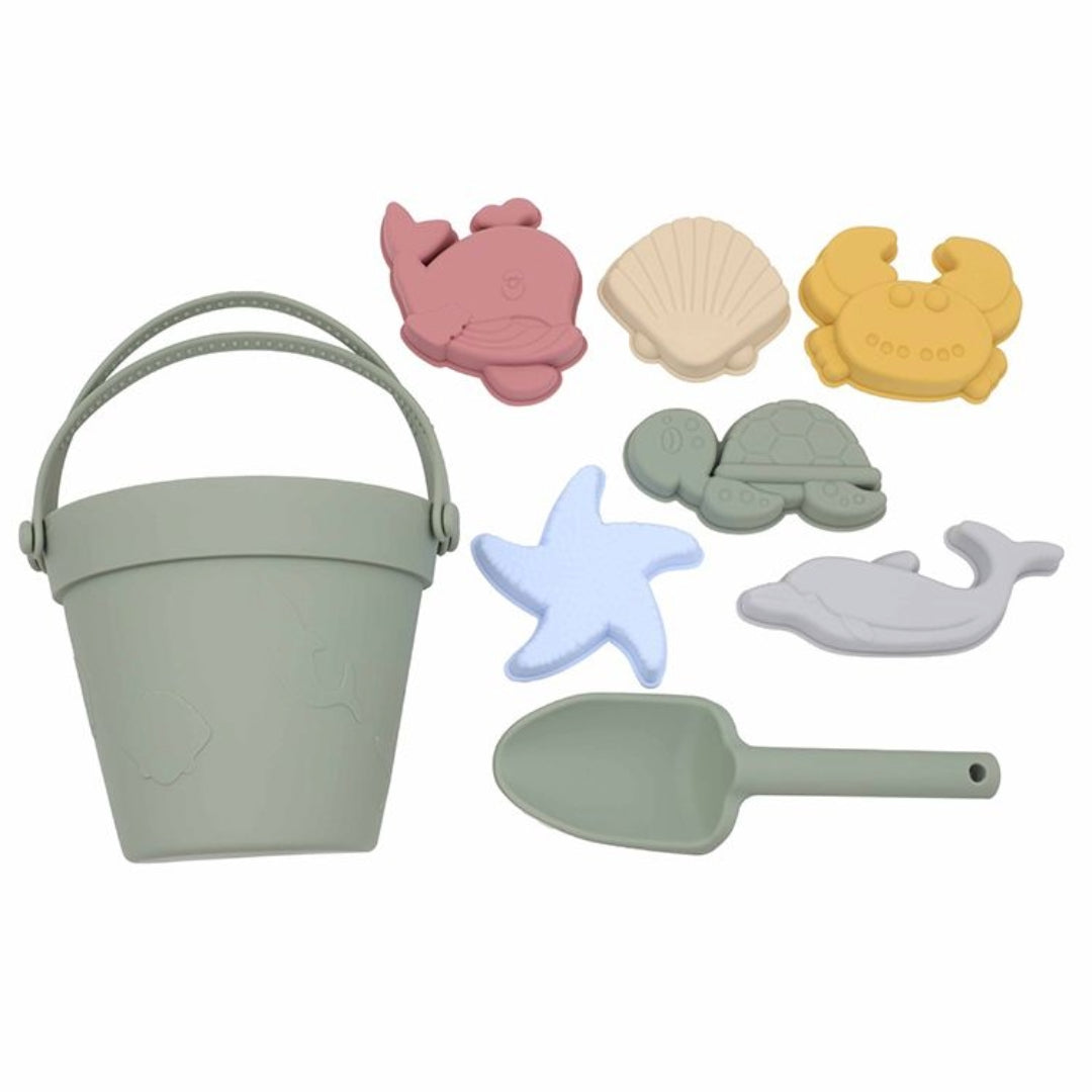 Complete Sage Green Silicone Beach Set including one bucket, one shovel, and five moulds laid out on a white background, highlighting the unbreakable and dishwasher-safe features of the hypoallergenic, BPA-free silicone toys.