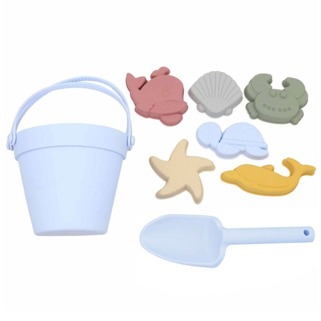 Complete Sky Blue Silicone Beach Set, including one bucket, one shovel, and five moulds laid out on a white background, highlighting the unbreakable and dishwasher-safe features of the hypoallergenic, BPA-free silicone toys.